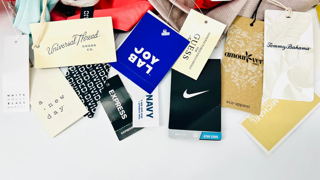 Assorted tags of the different brands that are available in the new with tags collection such as nike, tommy bahama, and michael kors.